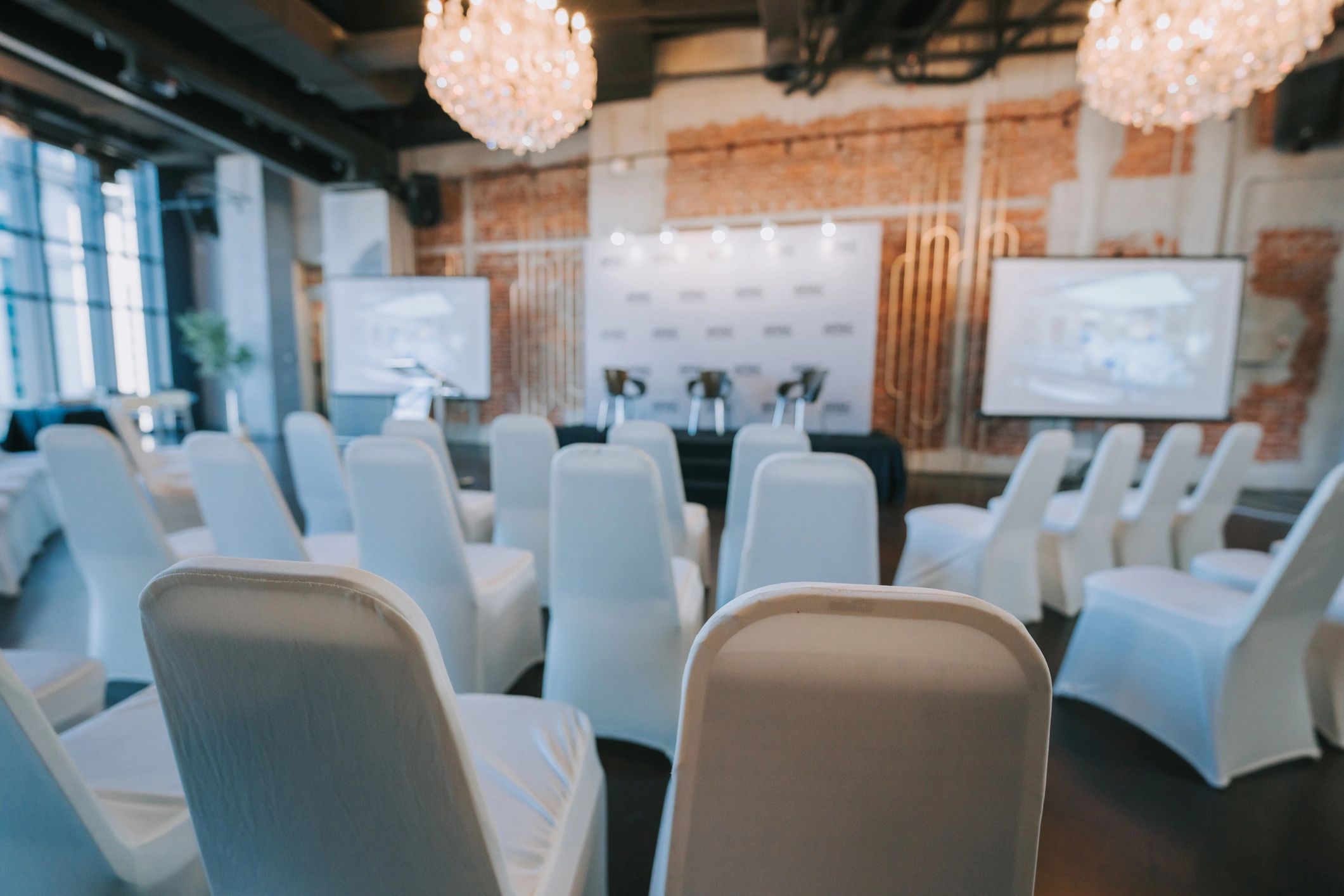 Conference setup with stage, projector screen, and seating