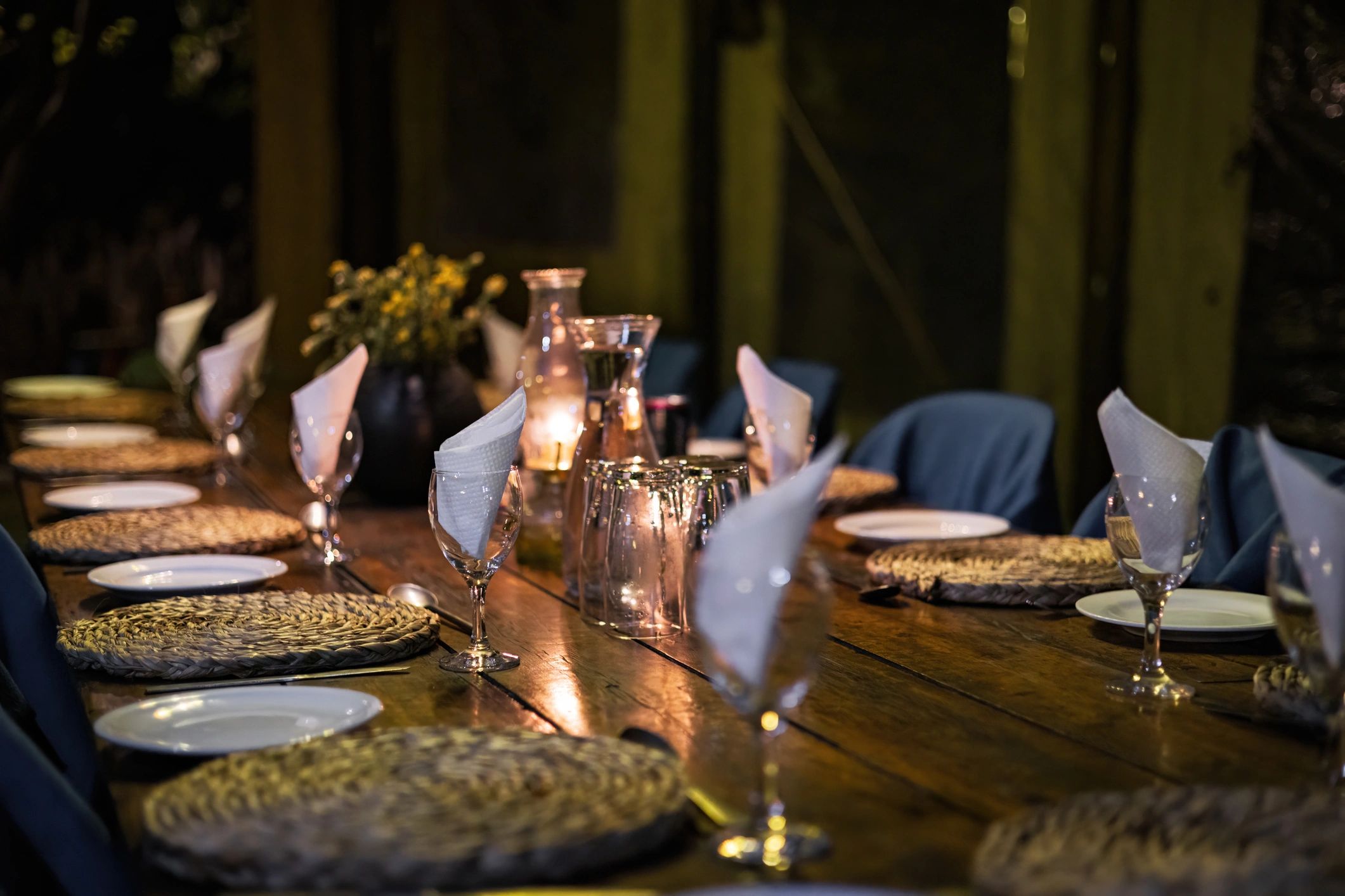 Candlelit dining table prepared for a celebration